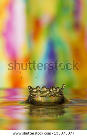Multi-colored tie dye reflected in water splash