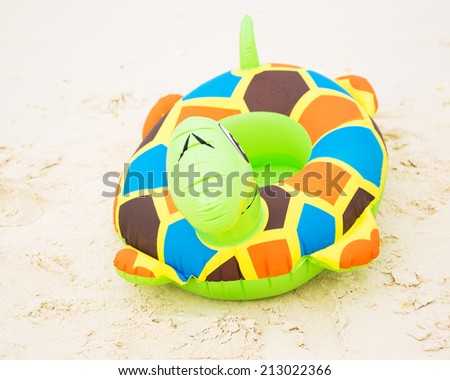 Swim ring on a white sand beach