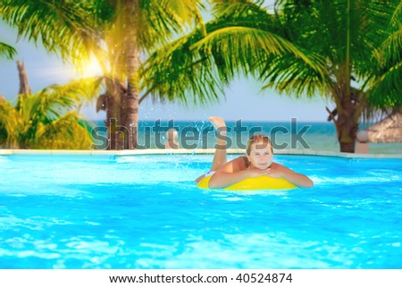 Funny woman with inflatable tube in swimming pool