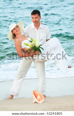 http://image.shutterstock.com/display_pic_with_logo/94147/94147,1274085249,1/stock-photo-man-carrying-woman-on-the-tropical-beach-53241805.jpg
