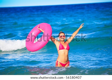 Happy woman with inner tube at the sea