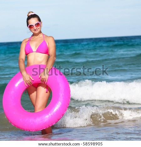 Woman with inner tube on the tropical beach