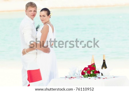 stock photo Bride and groom near the wedding table