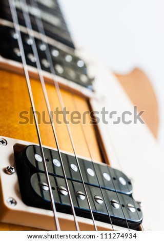 Electric guitar humbucker pickup honey burst color on white background isolate
