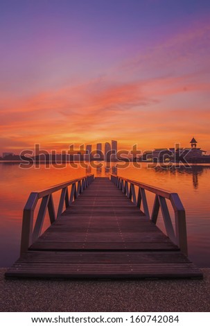 jetty at lakeside with colorful sunrise. Pullman, Putrajaya, Malaysia
