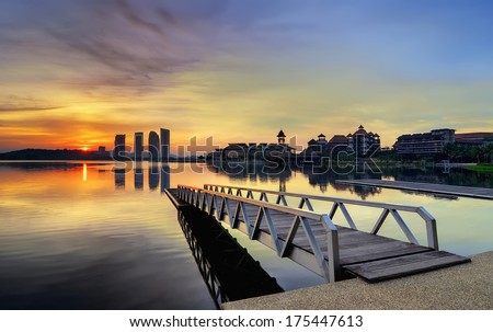 Jetty at lakeside with colorful sunrise. Pullman, Putrajaya, Malaysia