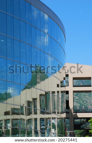 Circular building with windows reflecting other buildings in Salt Lake City, Utah.