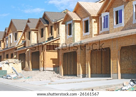 Rows of unfinished townhouses under construction.