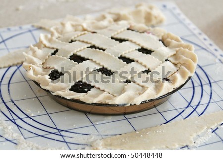 Homemade blueberry pie with lattice crust ready to go in the oven to be baked.