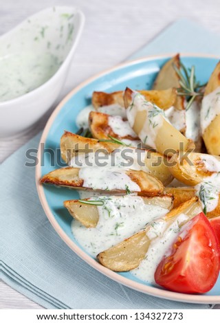 Baked potatoes with rosemary and white sauce