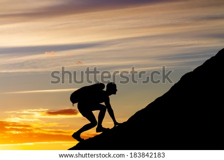 Silhouette of a man that climbs the mountain on sunset sky background. Climbing a mountain.