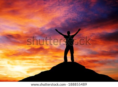 Silhouette of a man on a mountain top. Climbers on the top. Sport and active life concept