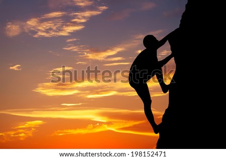 Rock climber at sunset background. Sport and active life