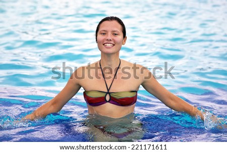 Smiling beautiful girl in a pool of aqua park