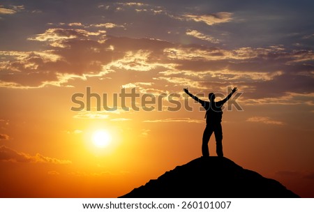 Silhouette of a man on a mountain top. Person silhouette on the rock. Sport and active life concept