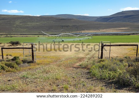 Gate leading to an agricultural farm with an irrigation system in the Northern Cape of South Africa