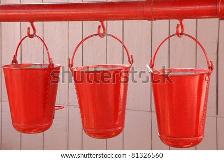 Three old, red fire buckets used to put out fires