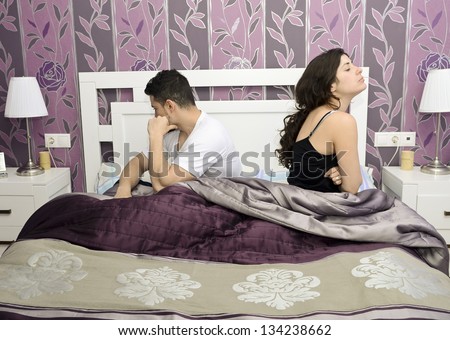 Angry couple in bedroom.