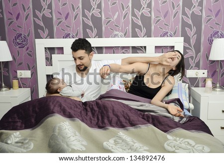 Man who care for his newborn. Prefers baby before his wife.Vintage bedroom.