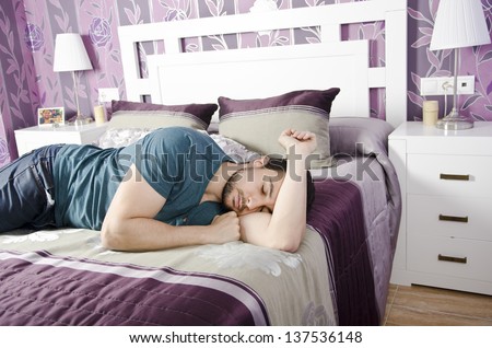 Sleeping tired man in vintage bedroom.