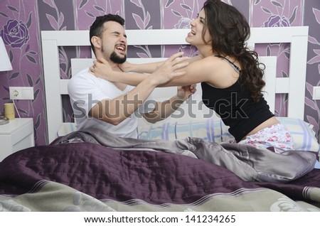 Discusses couple in bed, a fight that symbolizes marital conflicts.