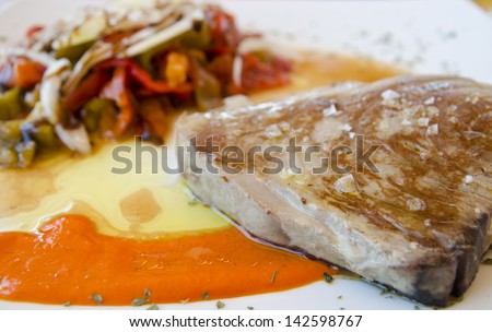 Grilled tuna steak grilled with pepper sauce and pepper salad.