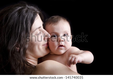 Mother kiss.Mother and baby on Black background