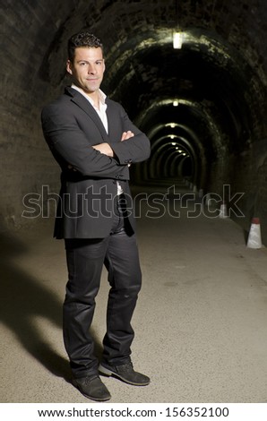 Suit Man in tunnel. Posing in darkness.