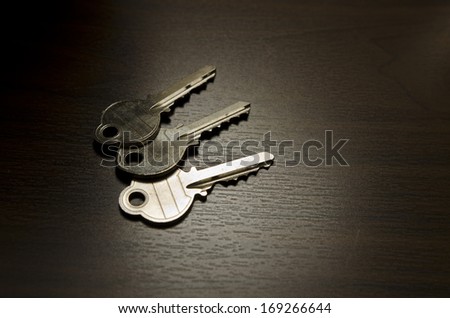 Low key image of keys on wood table
