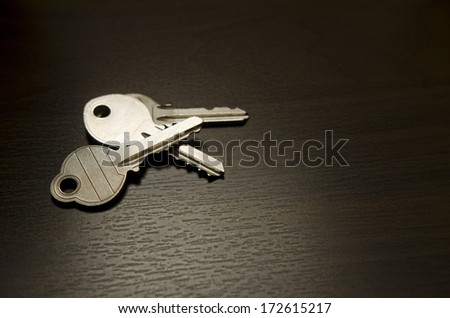 Low key image of a isolated bunch of keys on wood