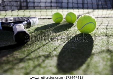 paddle tennis objects ion artificial turf ready for tournament with hard dramatic shadows.