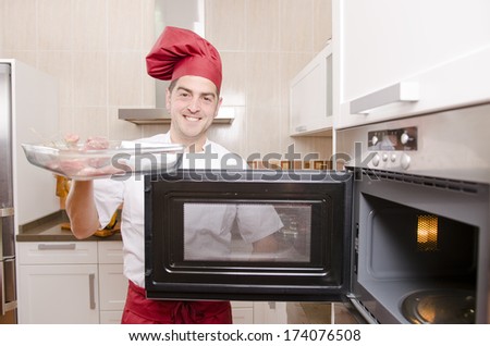 chef cooking with microwave oven in kitchen