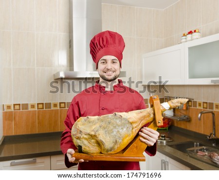 Chef with pig leg, spanish jamon serrano, typical product form spain.
