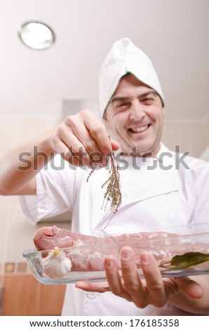 Chef in kitchen preparing raw ingredients for cook