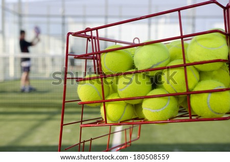 Paddle tennis training, balls and far player