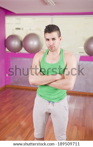 Fit guy posing in balloon fitness room