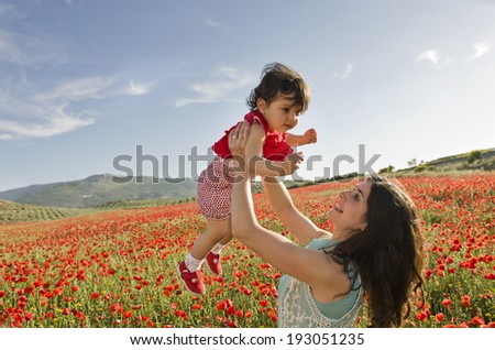 Baby with his mom enjoying a field day outdoors