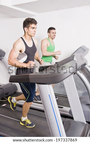 Friends running on gym train treadmill