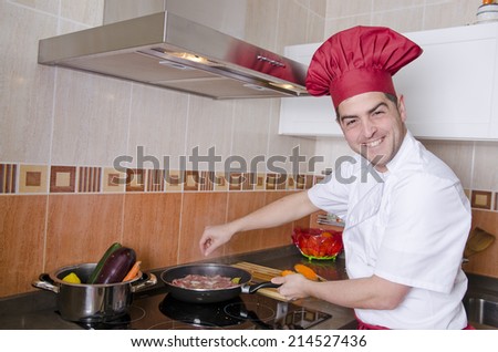 Smiling chef with domestic service uniform preparing pig tenderloin