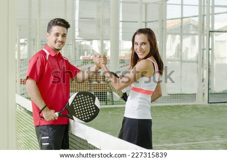 Man and woman are a paddle tennis team in mixed tournament