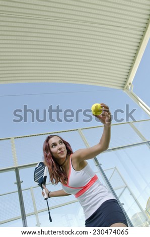 Paddle tennis woman ready for serve padel ball at indoor court