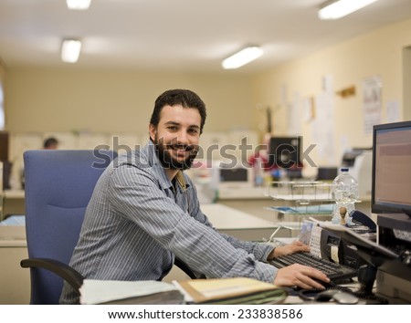 Image of real bearded office clerk working at office