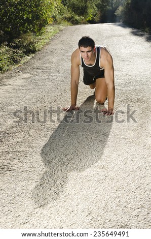 Runner man in the road with back light ready for sport activity