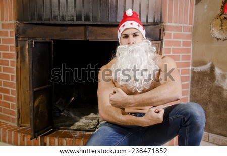 Fitness santa in chimney posing strong for health happy new year