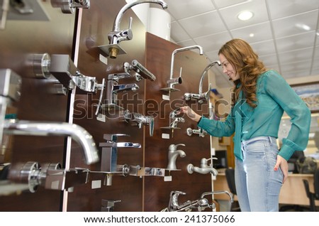 Woman at furniture and faucet store choosing for home decoration