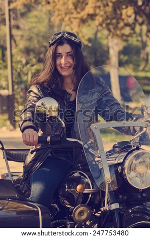 Casual woman at custom sidecar bike with vintage filter an natural light