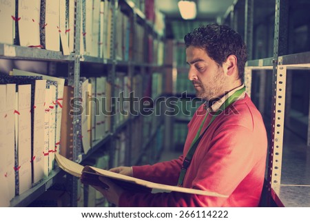 Office clerk looking files and papers at deposit