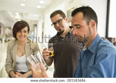 Group of people drinking alcohol at restaurant. Beer glass is empty