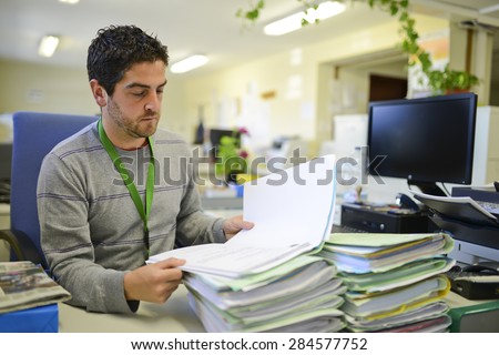Office worker reading fies at office