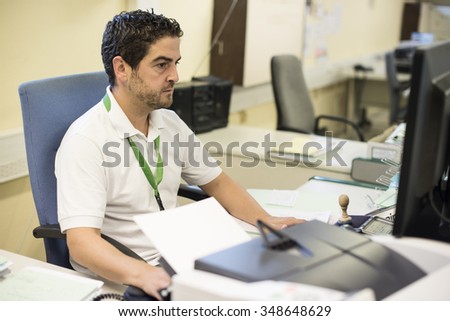 Middle-aged man working at his office using computer.